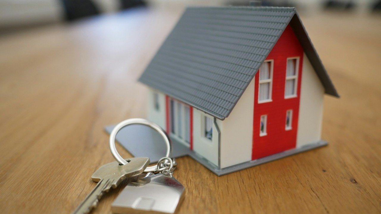 House keys and new residential home architectural model