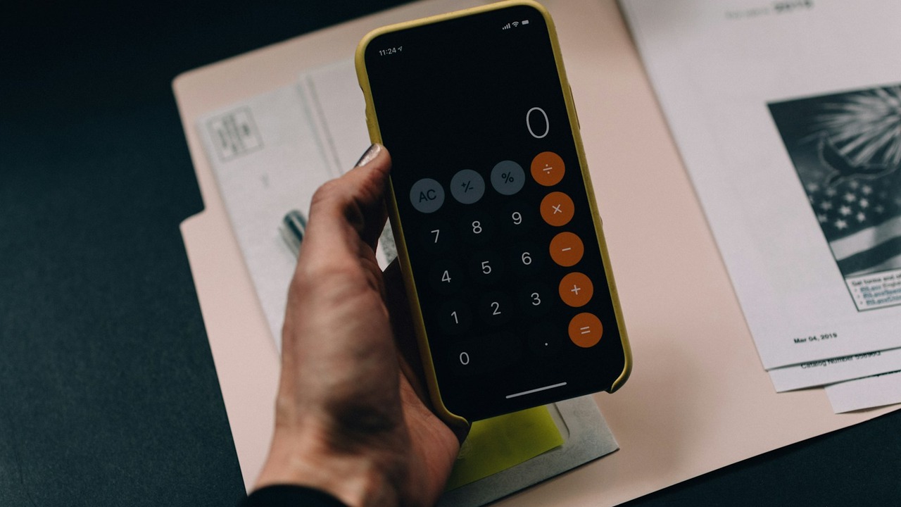 Household financial planning desk with notebook, documents, and calculator